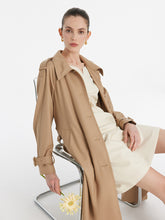 A lady wears a worsted wool trench coat.